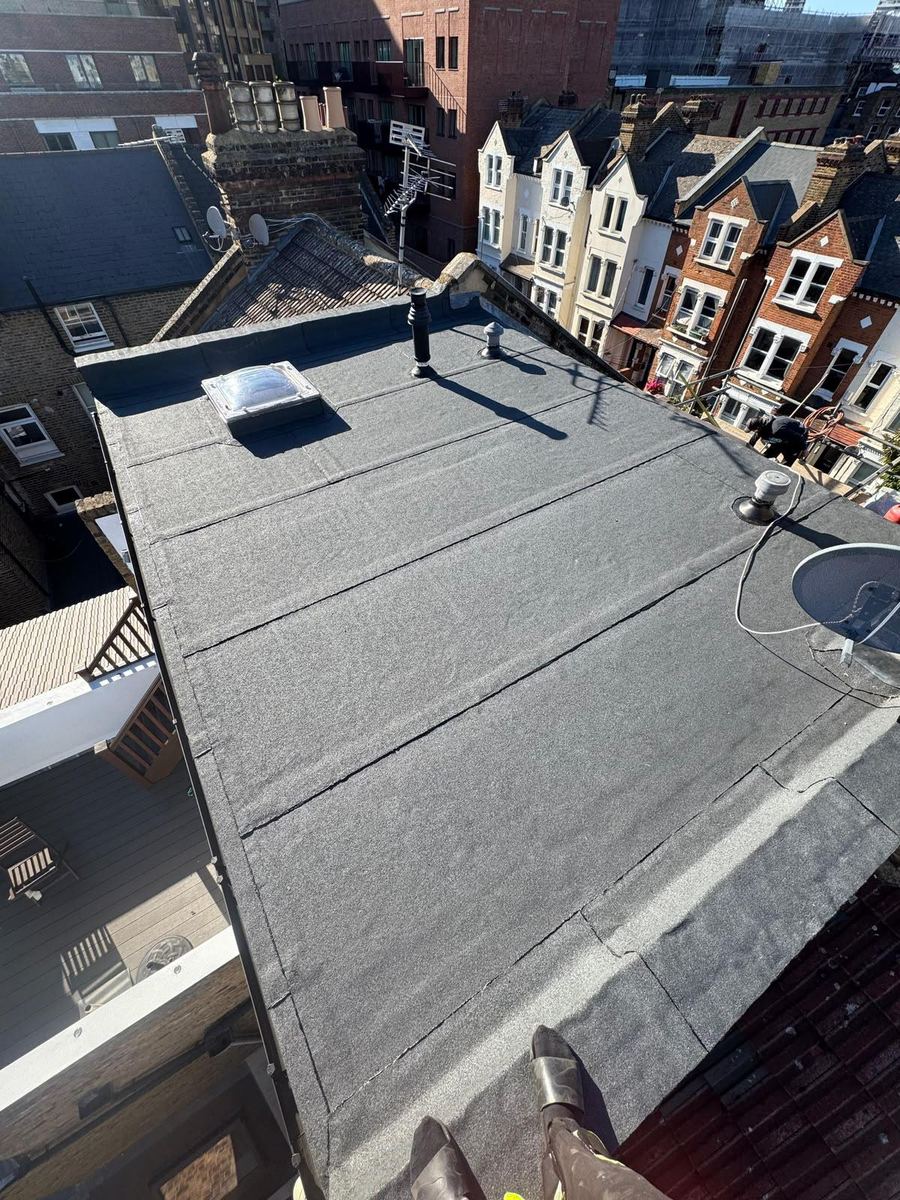 A large flat roof above a terraced row