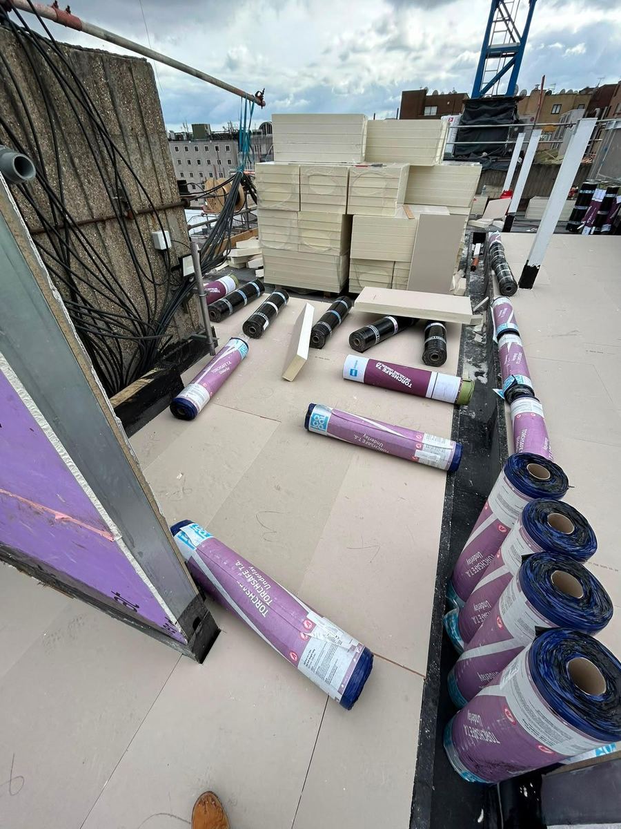 Insulation boards and membrane rolls laid out on site